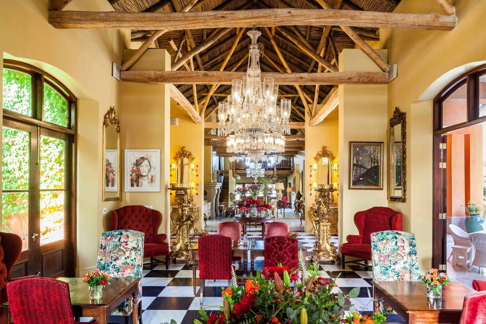 a hall with beams and chandeliers