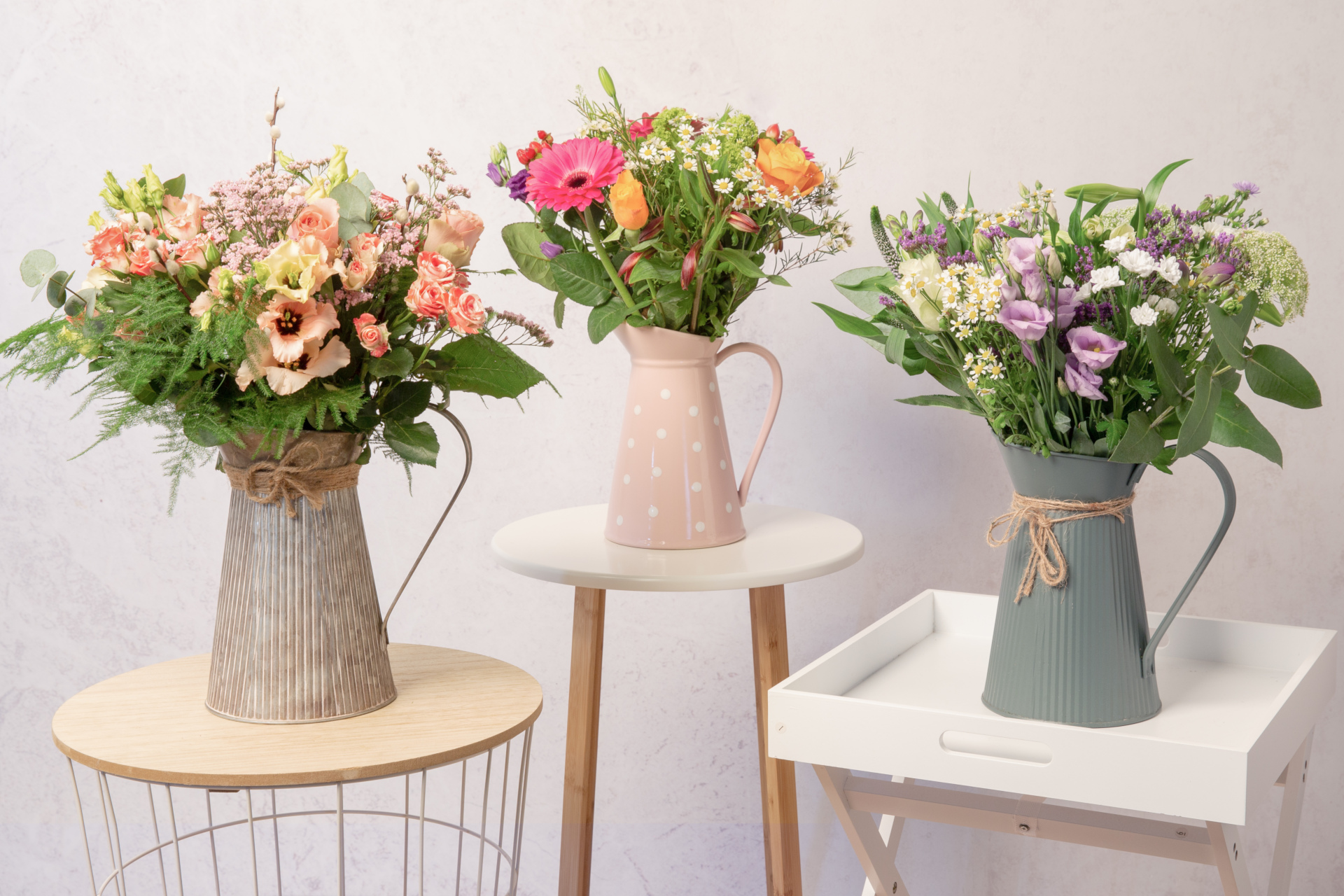 Vases of flowers set on stools