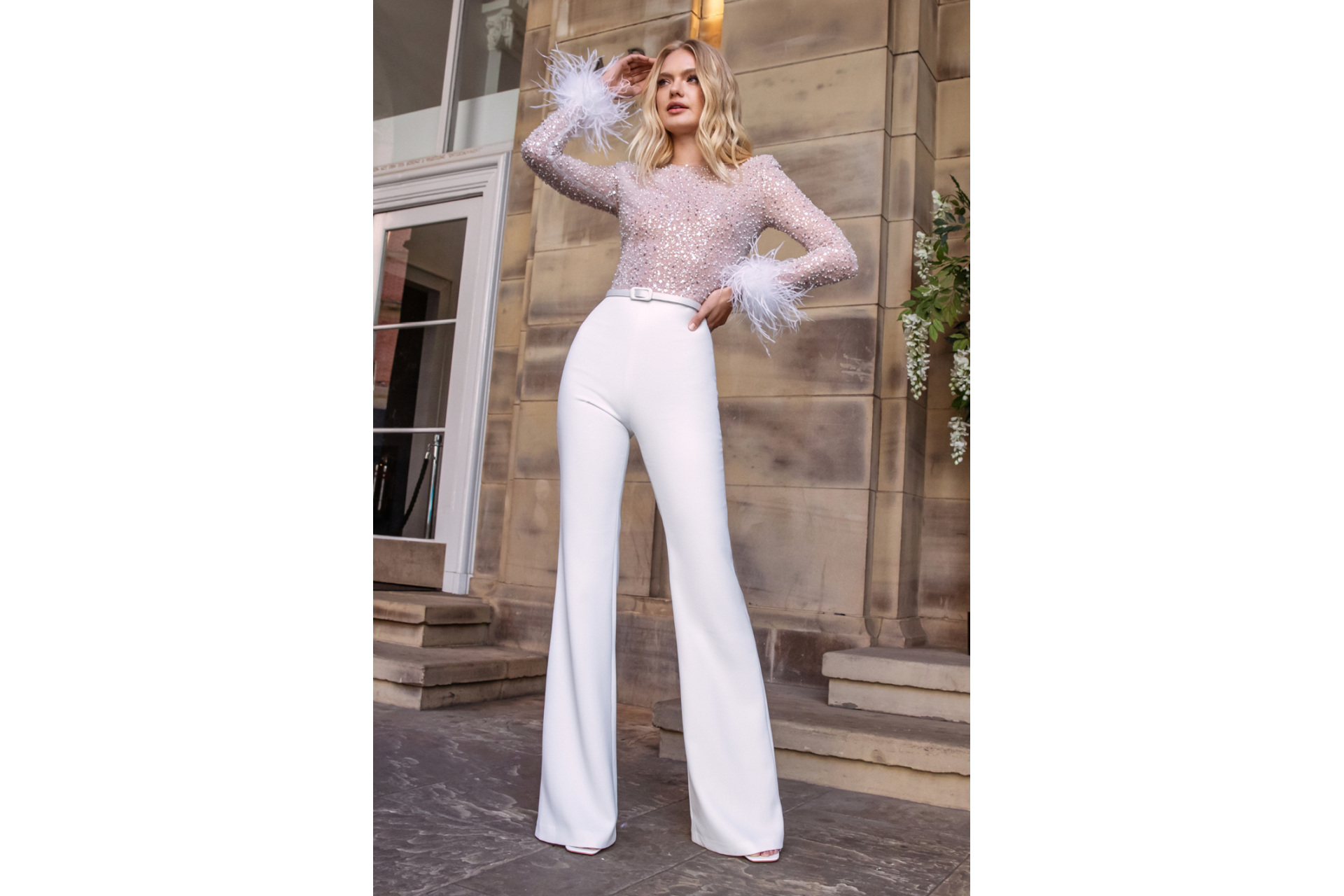 Woman in white sequin jumpsuit