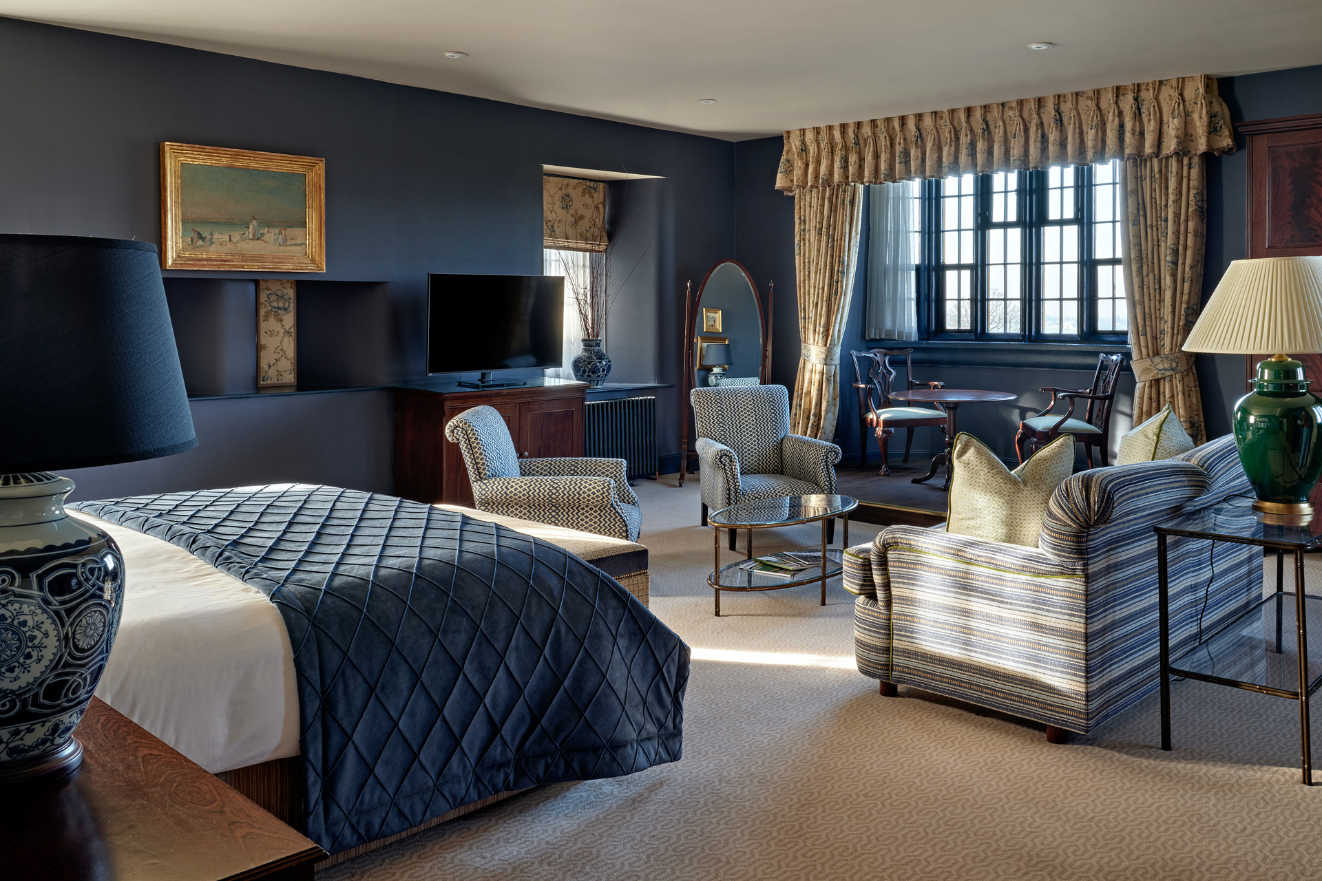 Suite with blue accents and a large seating area