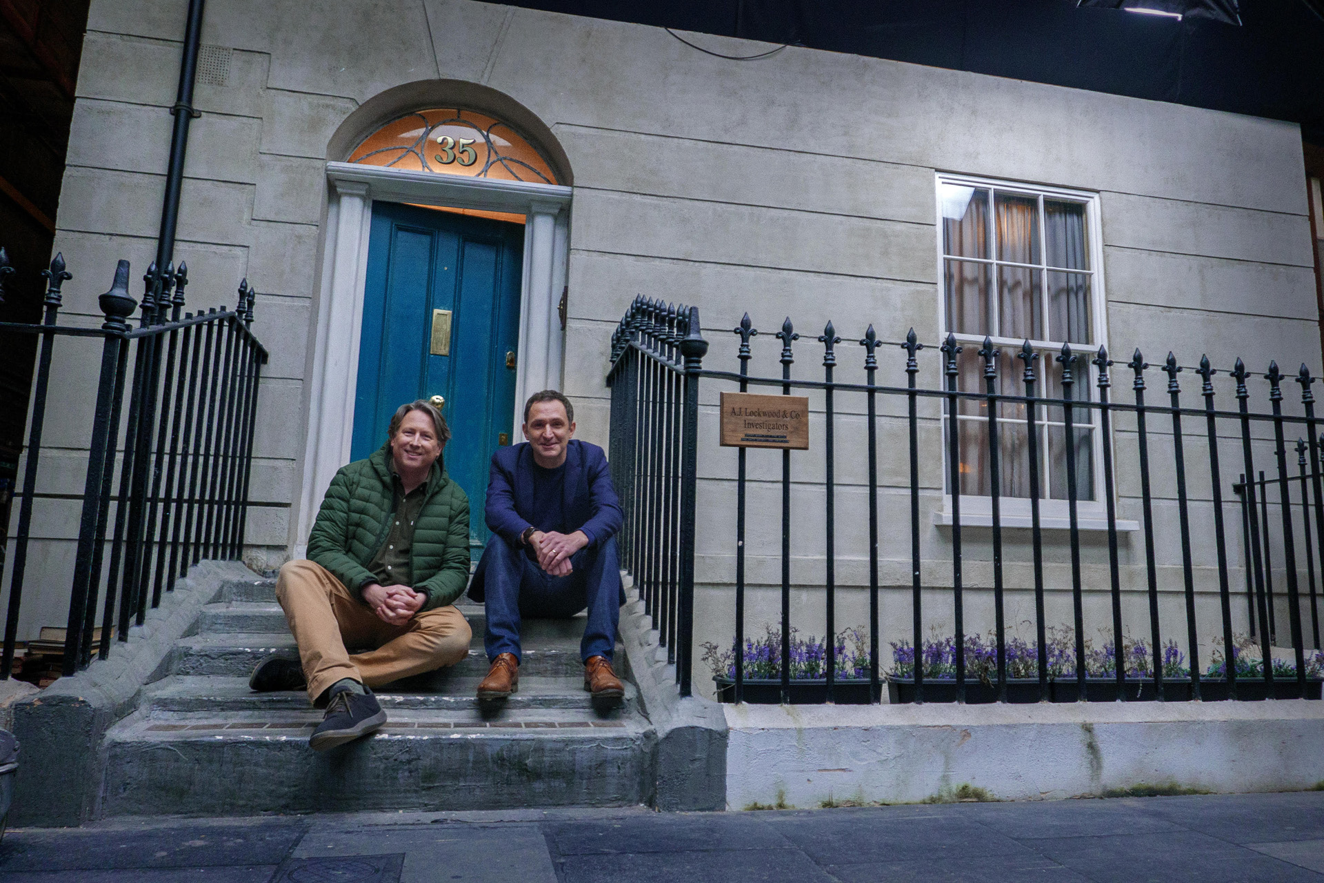 Series creator Joe Cornish and author Jonathan Stroud outside the version of Portland Row created on set.