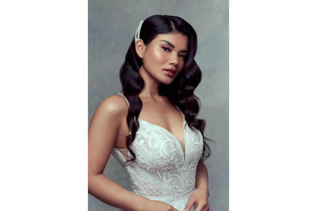 Bride with long wavy hair held up with a white clip