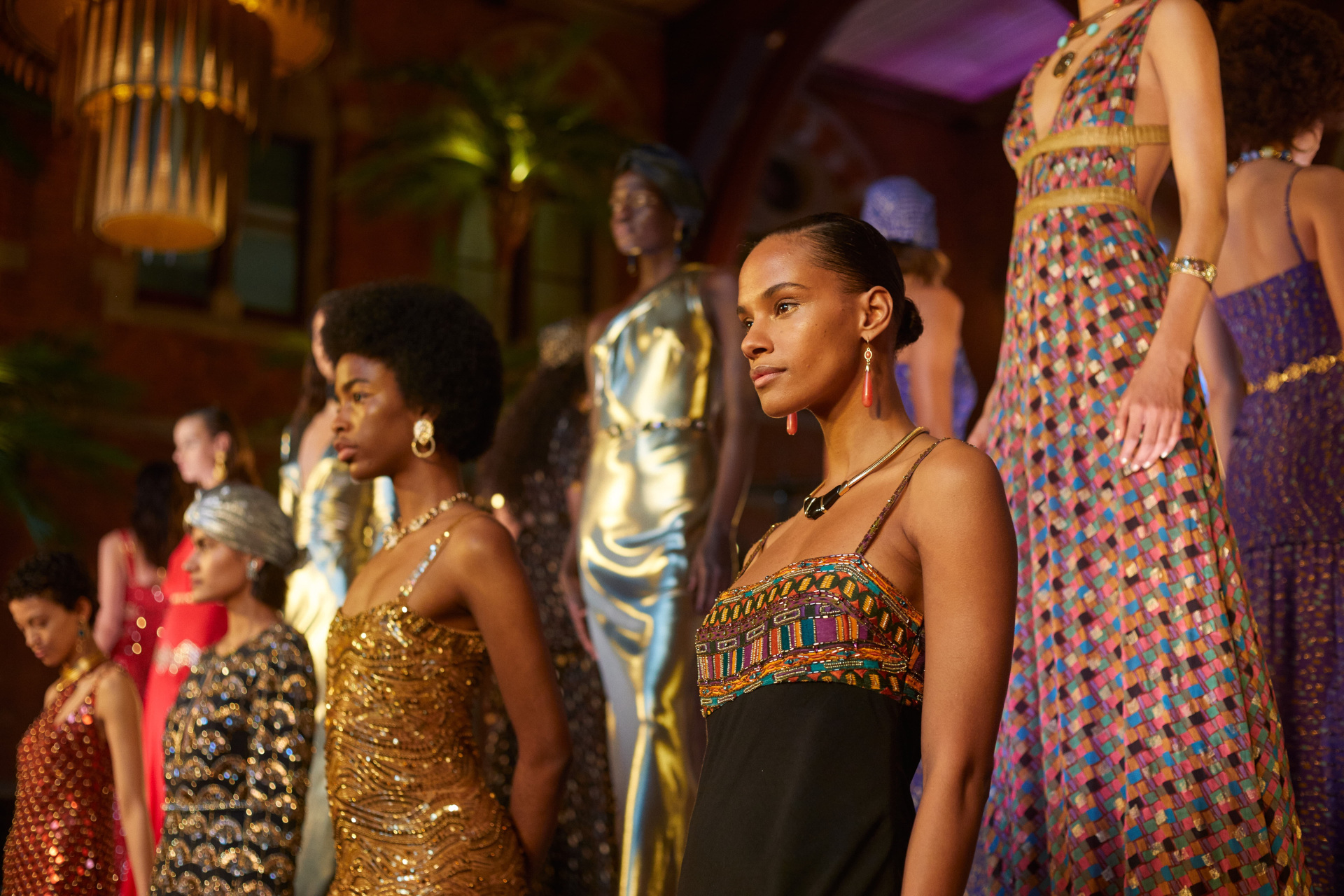 Models in evening gowns stood on raised tiered platform