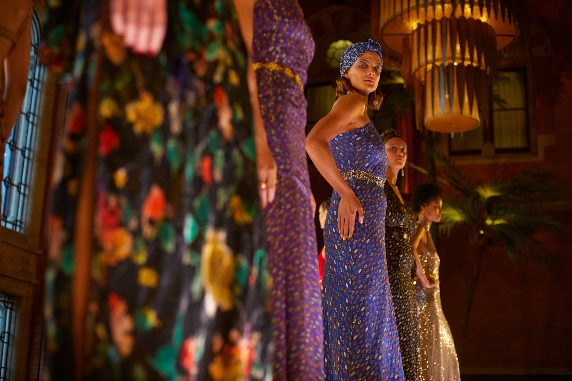 Close up of line of models in evening gowns