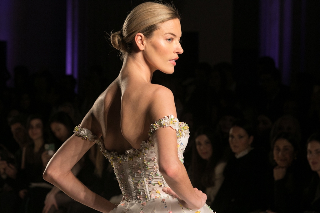 Woman with a tight bun wearing a corseted dress