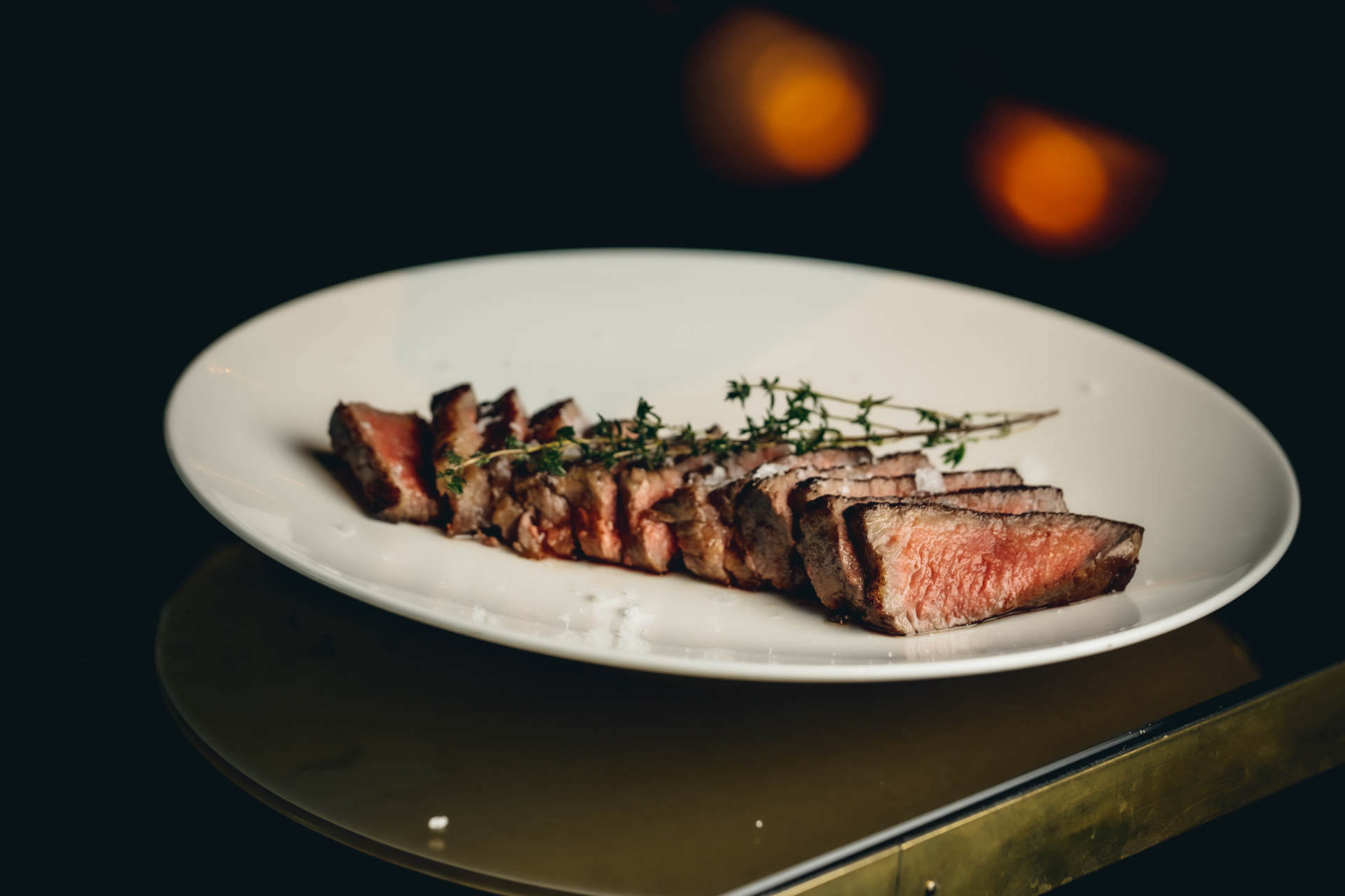 Steak cut up on a white plate