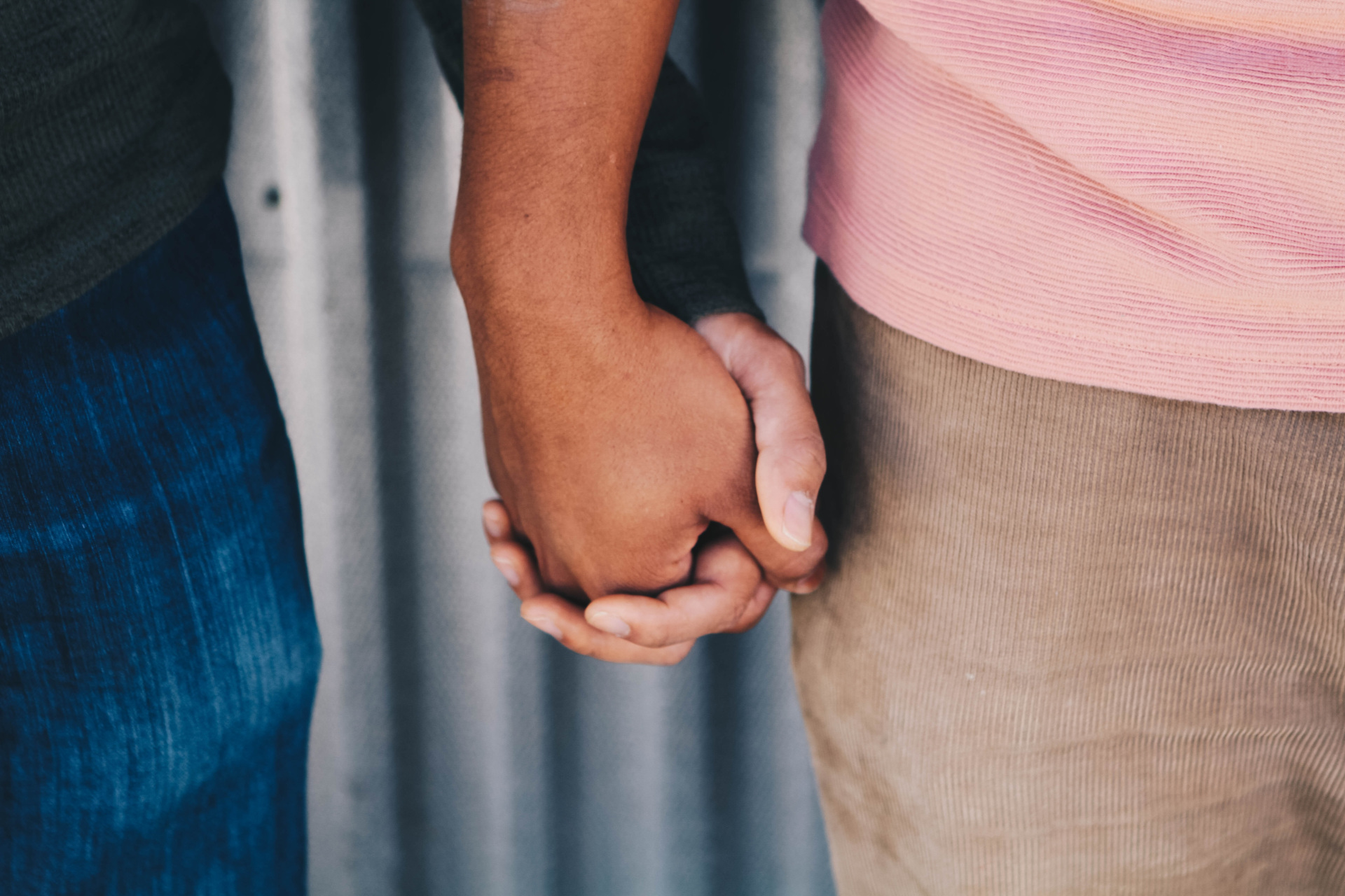 Close up of men holding hands