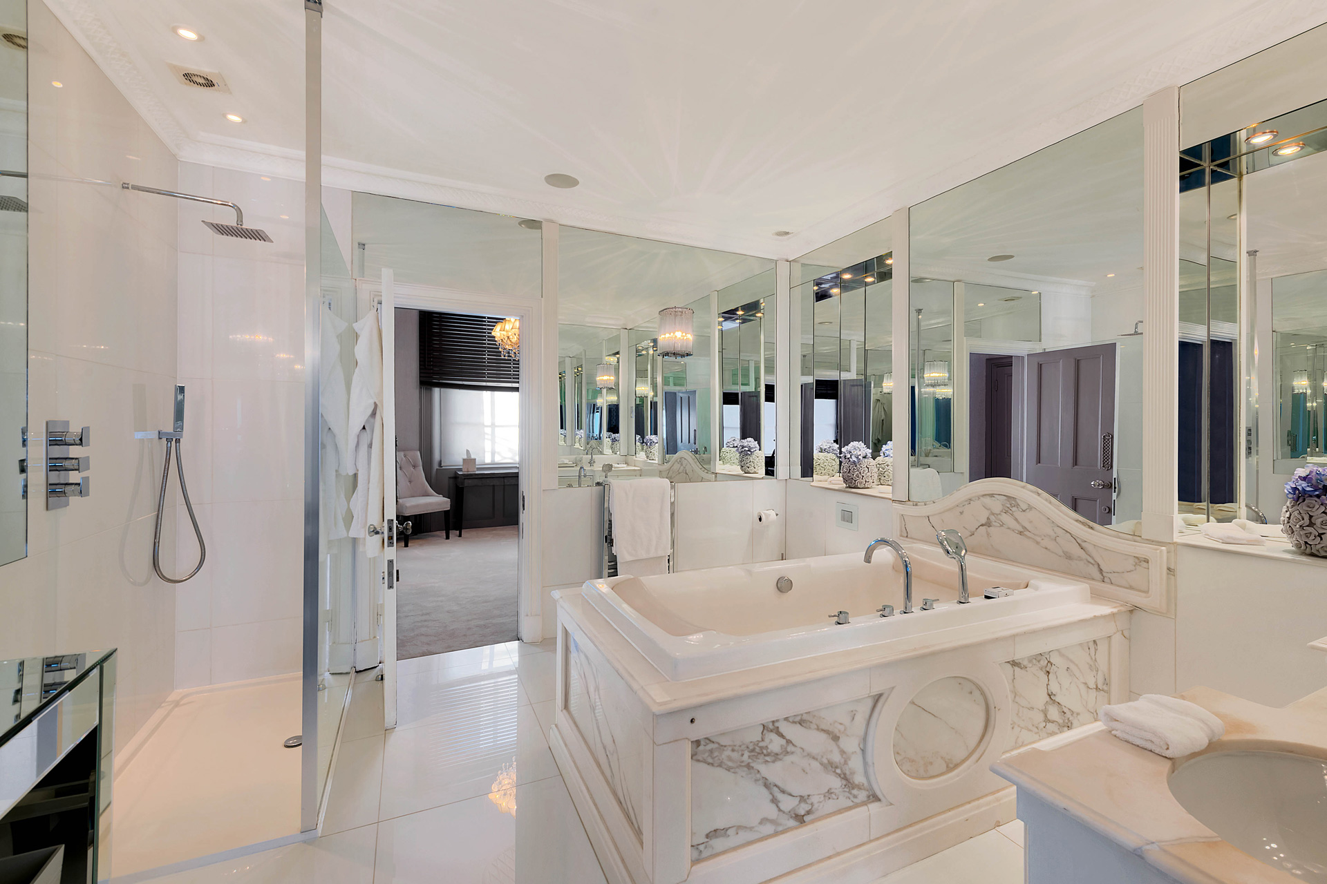 White marble bathroom with large bath