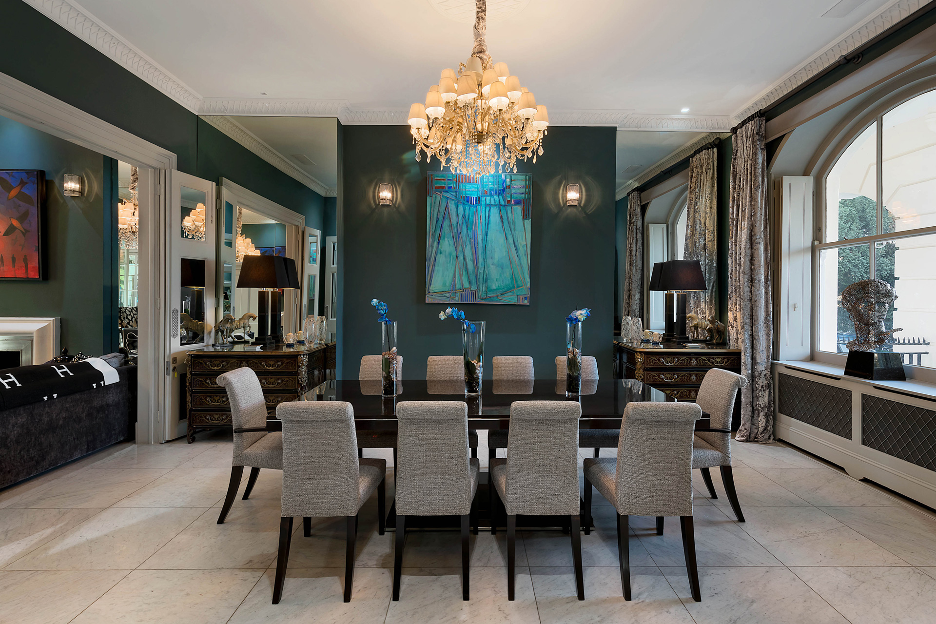 Dining room with grey chairs and blue artwork 
