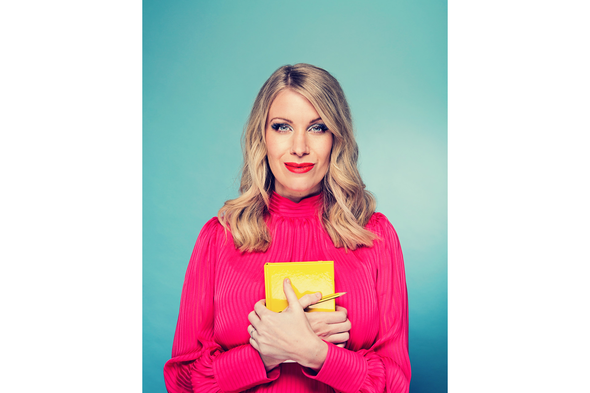 Rachel Parris holding a yellow book