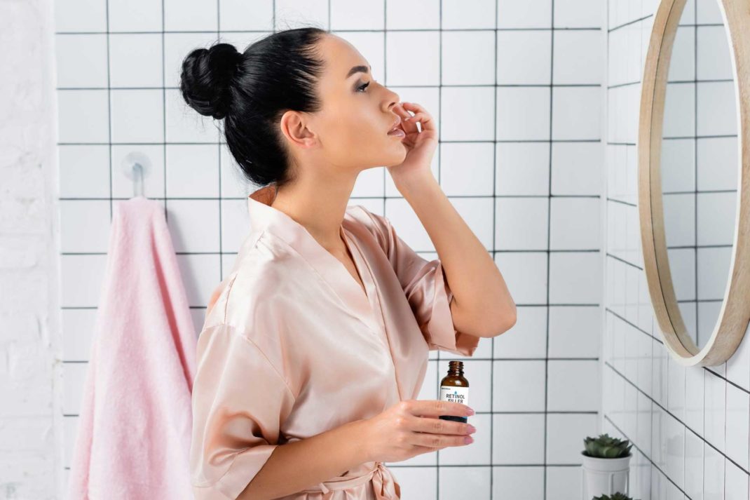 woman looking in bathroom mirror