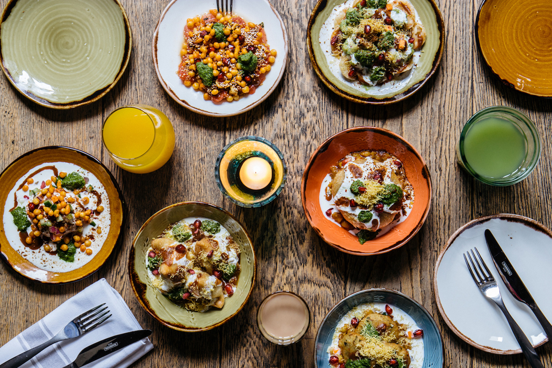 Dishes of Indian brunch food including eggs, chickpeas and daal.