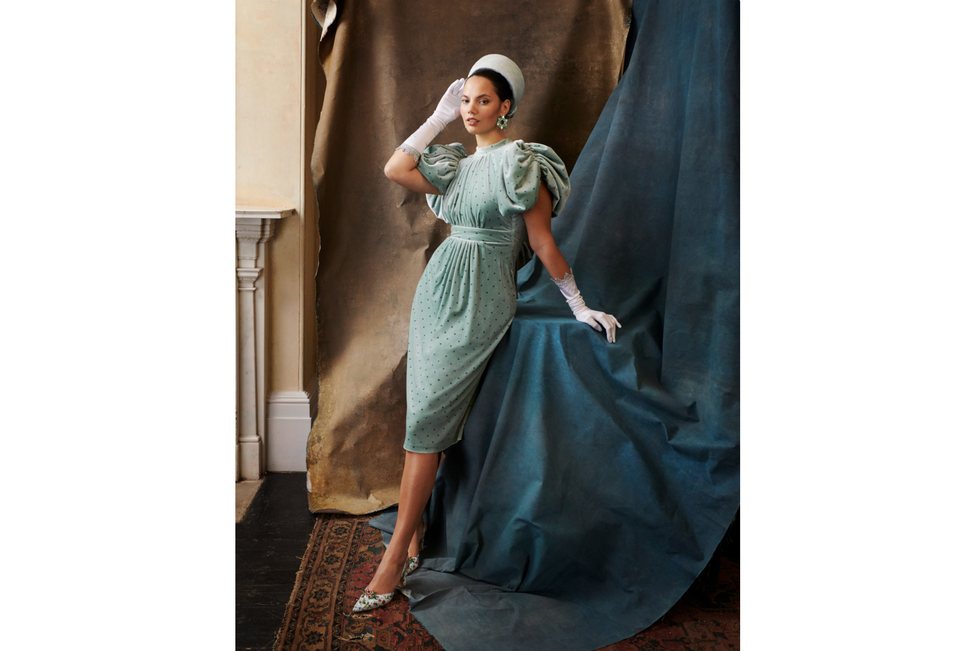 Woman in blue dress wearing white glove and hat