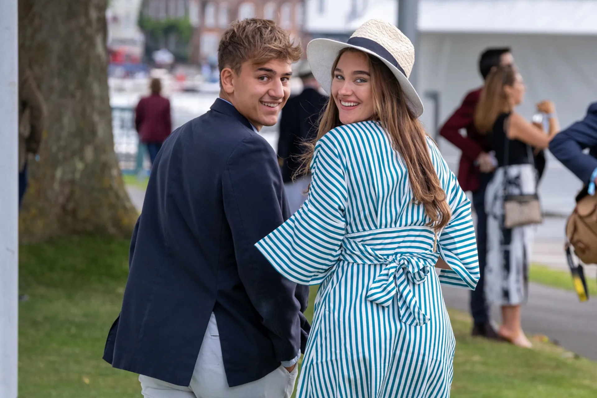 A couple looking over their shoulder and smiling