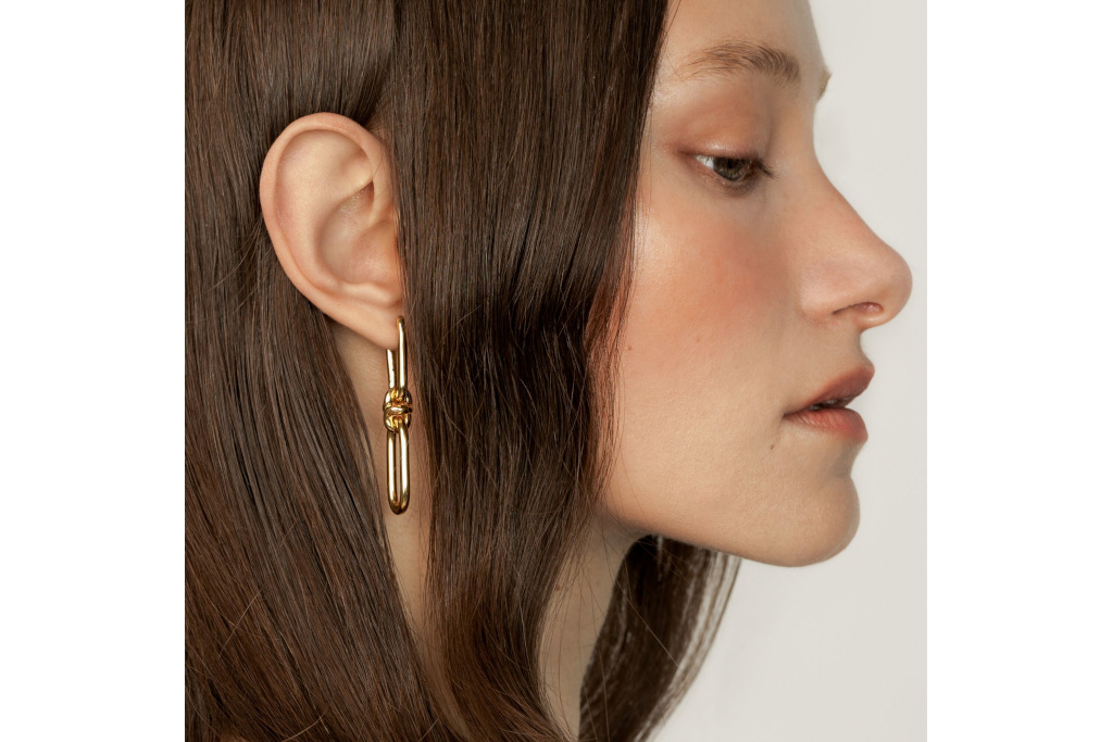 Woman wearing gold chain earring