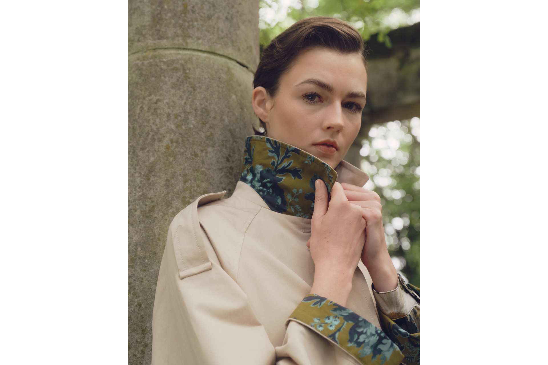 Woman pulling up collar of coat