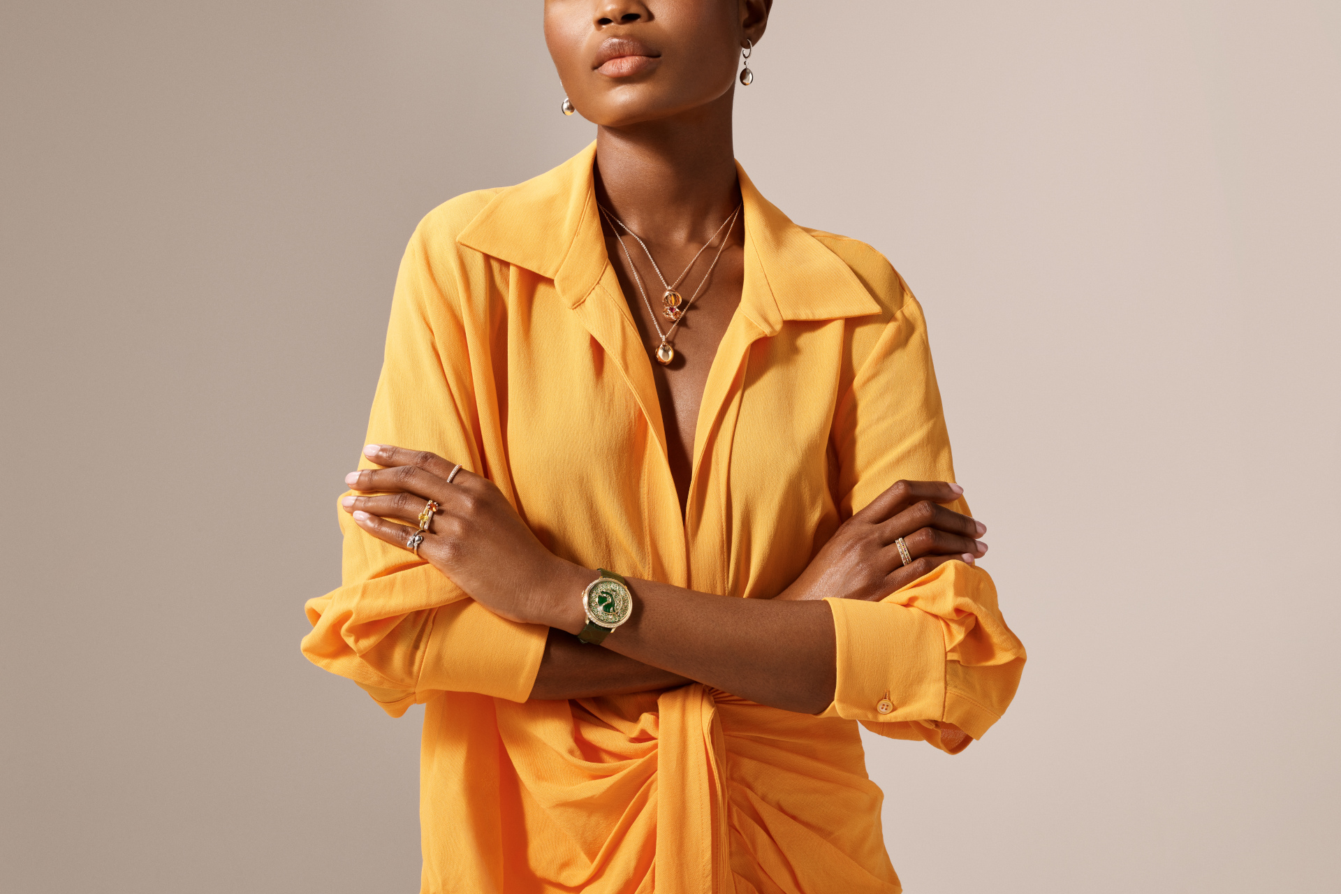 Woman in orange shirt and gold jewellery