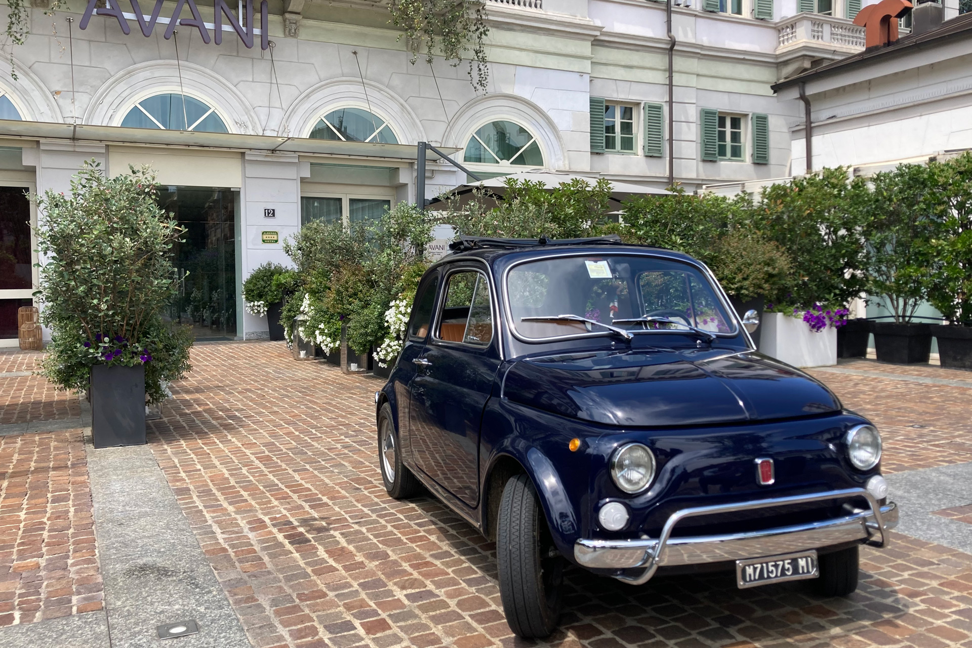 Old Fiat 500 parked in Milan