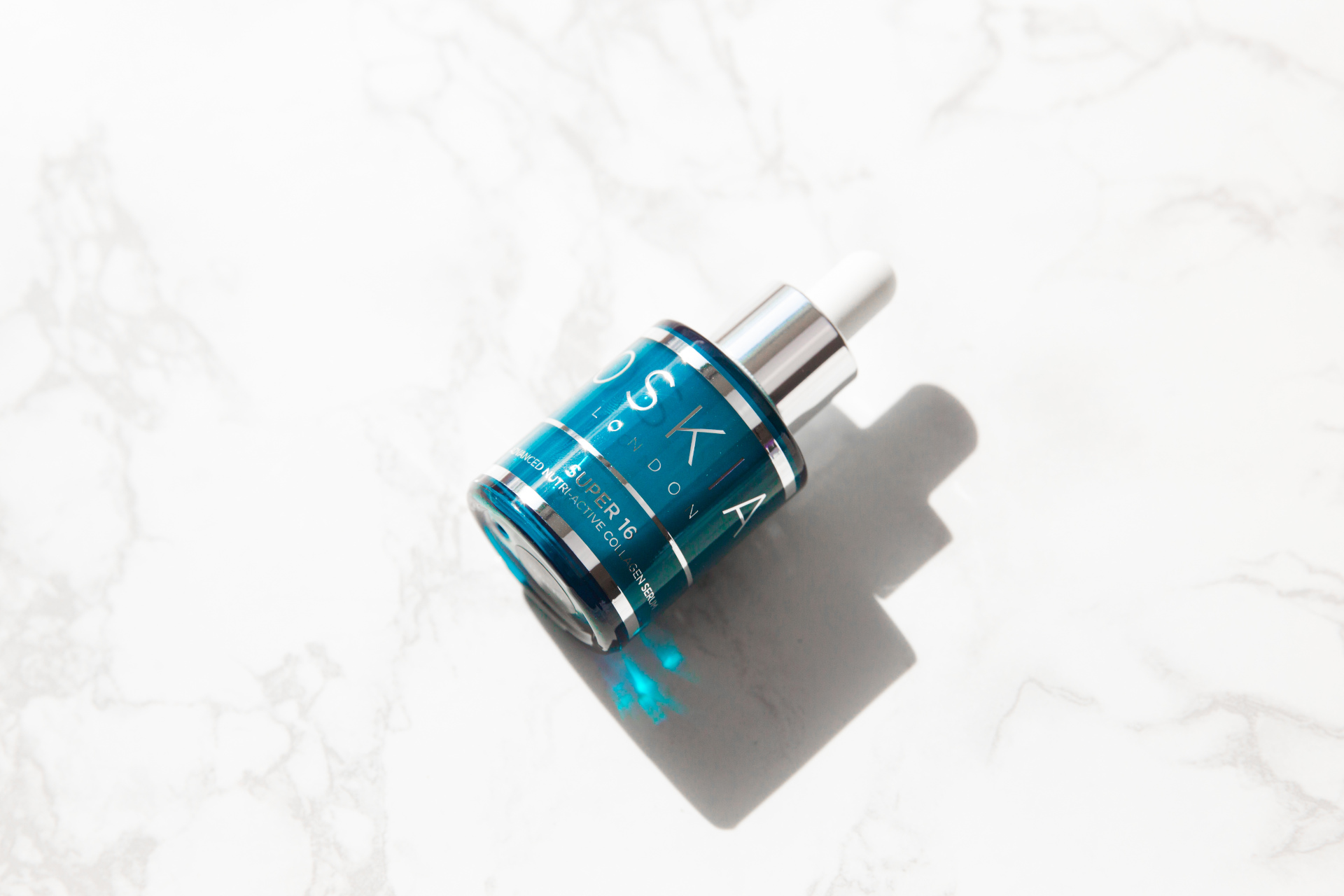 Blue serum bottle on its side