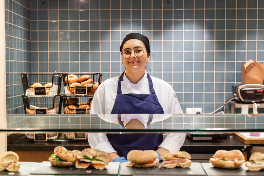 Woman behind bagel counter