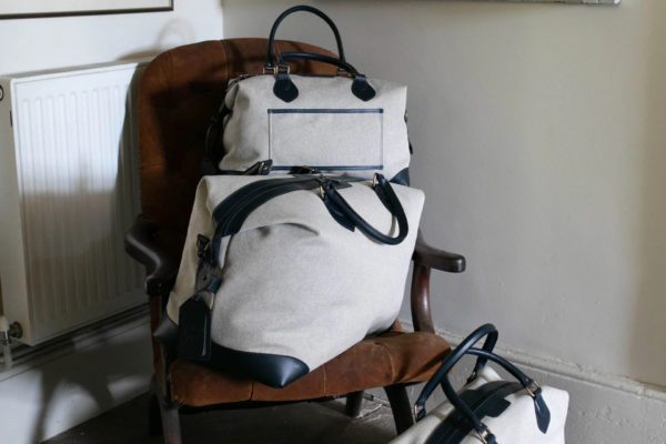 Holdalls stacked on chair