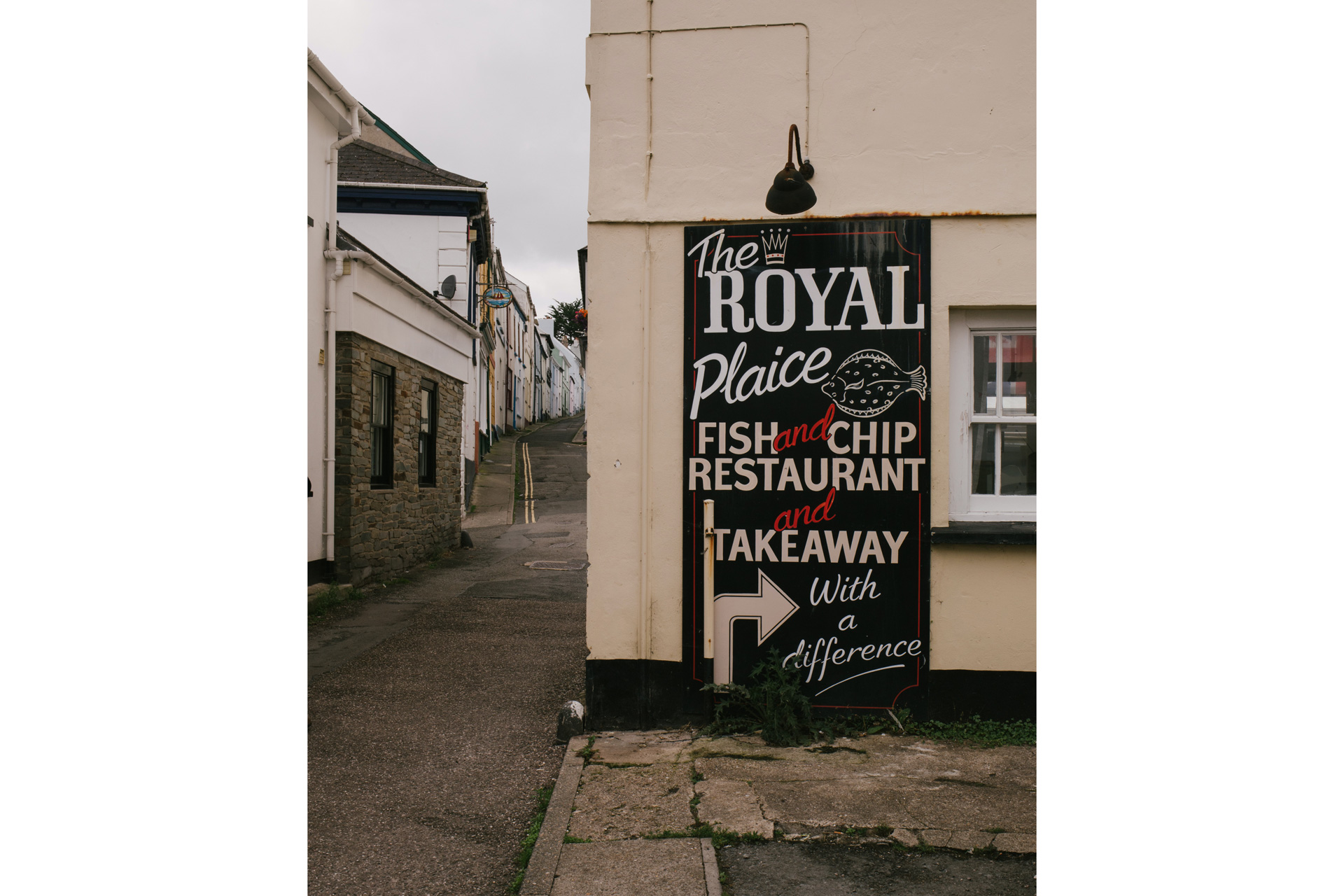 Sign pointing to a fish and chip shop